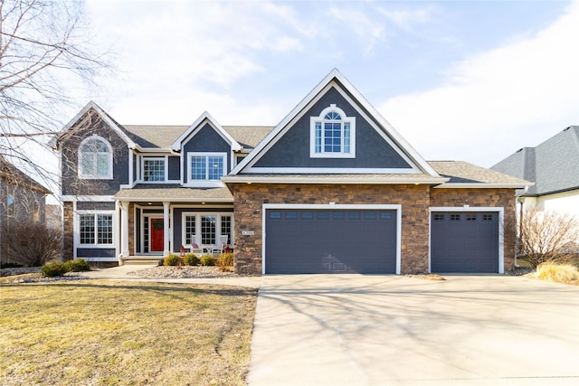 view of front facade with a shingled roof, a front lawn, concrete driveway, stucco siding, and an attached garage