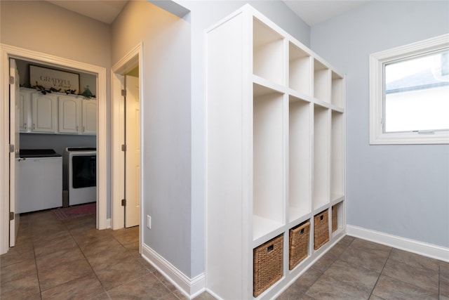 mudroom with tile patterned flooring, separate washer and dryer, and baseboards