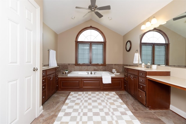 bathroom featuring plenty of natural light, a garden tub, a ceiling fan, and vaulted ceiling