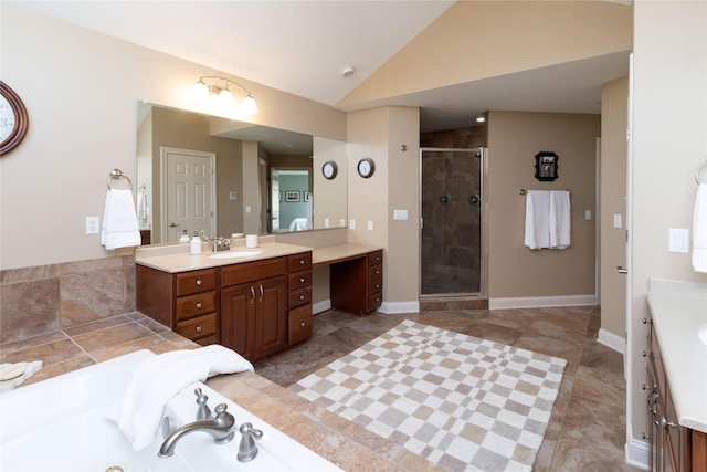 full bath with baseboards, a garden tub, vaulted ceiling, a stall shower, and vanity