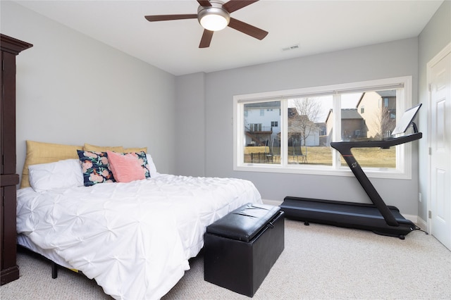 carpeted bedroom featuring visible vents, baseboards, and ceiling fan