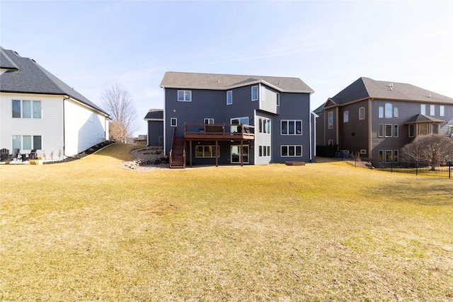 rear view of property featuring a deck, a yard, stairs, and a residential view