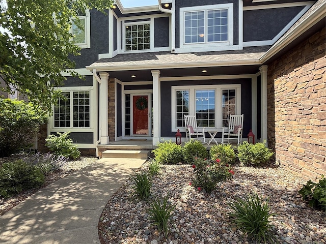 4300 161st St, Urbandale, IA 50323 - entrance to property featuring covered porch, stucco siding, and stone siding