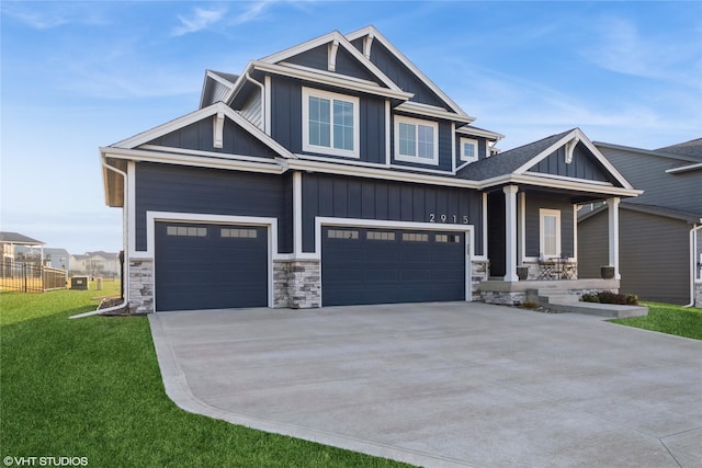 craftsman-style home featuring a porch, concrete driveway, a front lawn, a garage, and board and batten siding