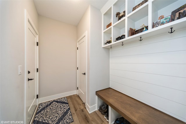 mudroom featuring light wood-style flooring and baseboards