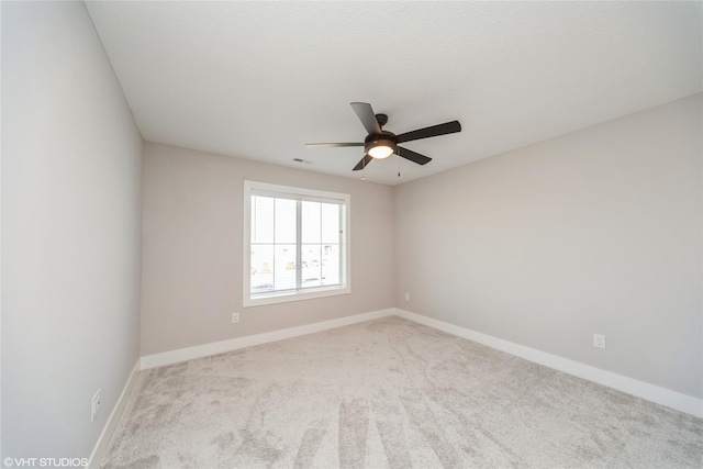 unfurnished room with baseboards, ceiling fan, and carpet flooring