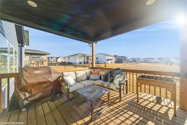 wooden deck with an outdoor living space, a residential view, and a grill