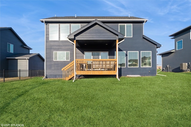 rear view of property featuring a yard, central air condition unit, a wooden deck, and fence