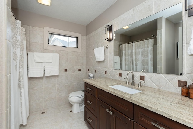 bathroom with vanity, curtained shower, tile walls, toilet, and backsplash