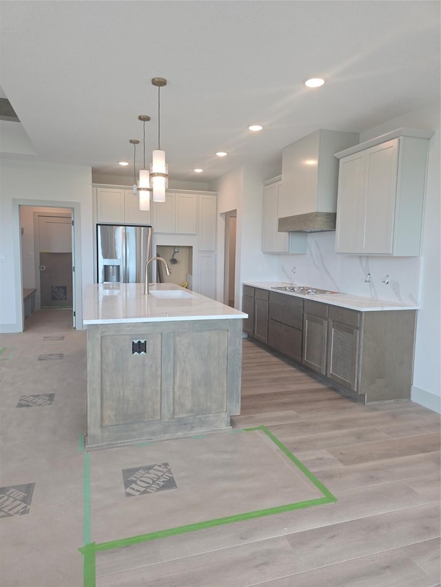 16203 Goodman Dr, Urbandale, IA 50323 - kitchen featuring stainless steel fridge with ice dispenser, stovetop, light countertops, light wood-type flooring, and recessed lighting