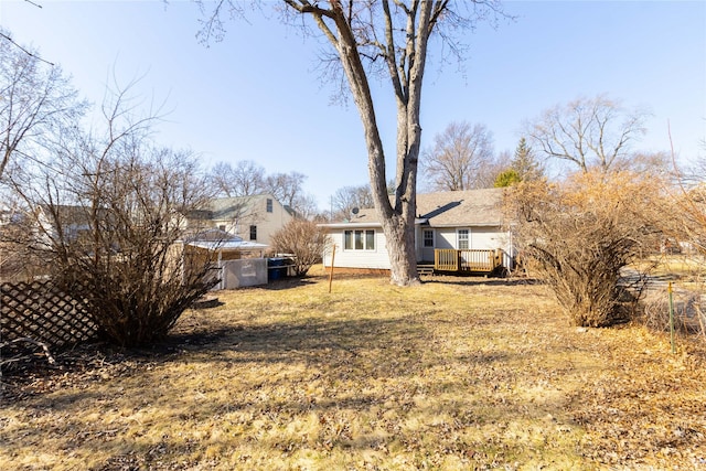 view of yard with a deck and fence