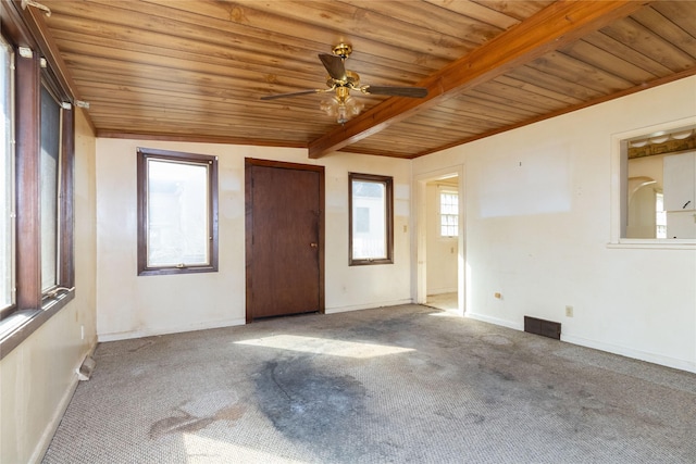 spare room with beam ceiling, visible vents, carpet, and a ceiling fan