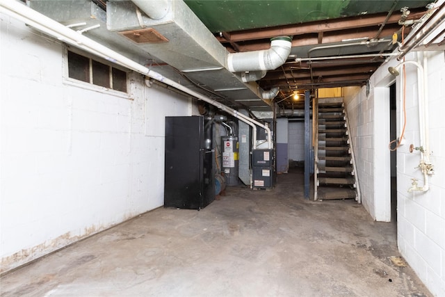 unfinished basement with stairs, heating unit, and water heater