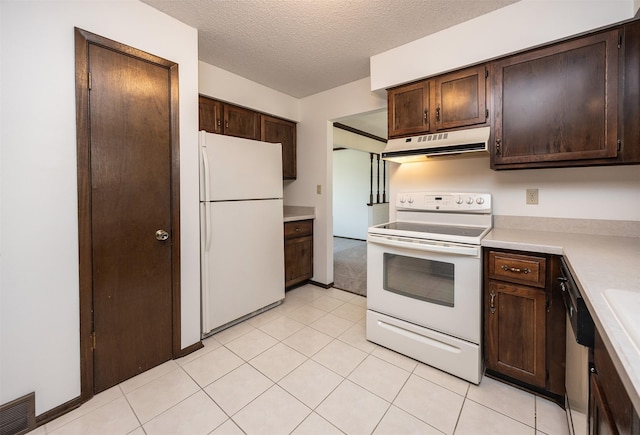 kitchen featuring white appliances, visible vents, light countertops, dark brown cabinets, and under cabinet range hood