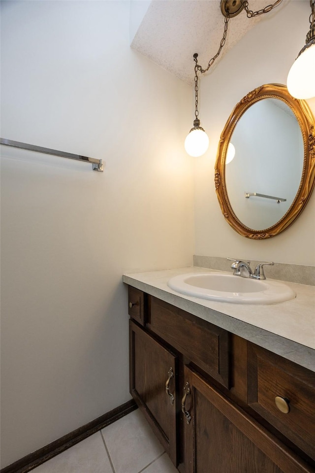 bathroom with tile patterned flooring, vanity, and baseboards