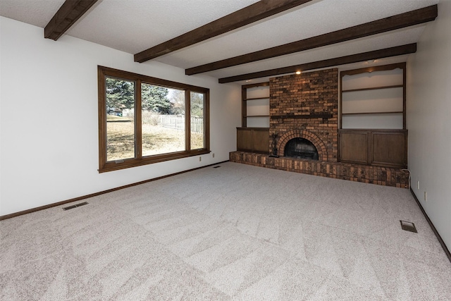 unfurnished living room featuring visible vents, beam ceiling, baseboards, and carpet flooring