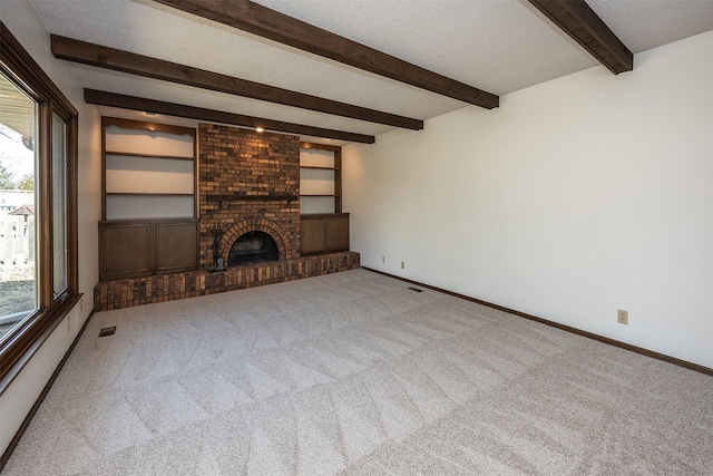 unfurnished living room featuring visible vents, a textured ceiling, a fireplace, carpet flooring, and baseboards