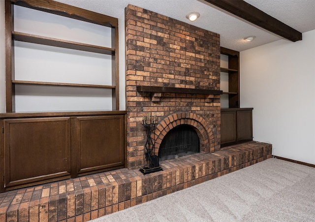 unfurnished living room featuring a brick fireplace, baseboards, beamed ceiling, carpet flooring, and a textured ceiling