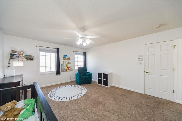 carpeted bedroom with a ceiling fan and baseboards