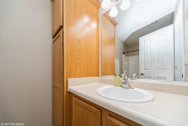 full bath with vanity, visible vents, and walk in shower