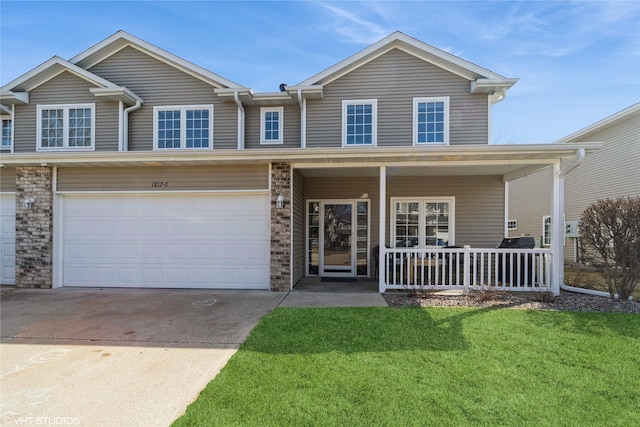 view of front of house featuring a porch, a garage, driveway, and a front lawn