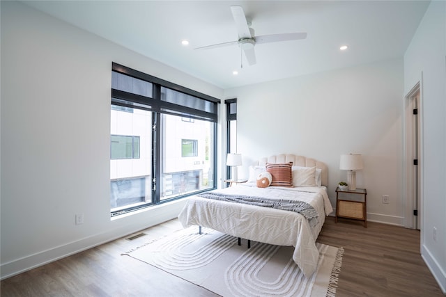 bedroom featuring visible vents, ceiling fan, baseboards, recessed lighting, and wood finished floors