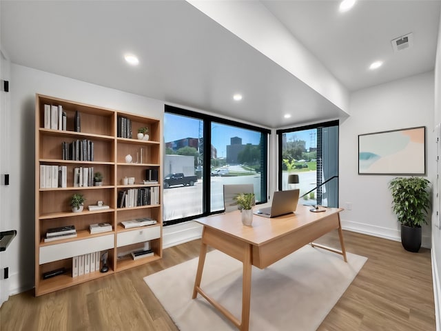 office featuring recessed lighting, visible vents, baseboards, and wood finished floors