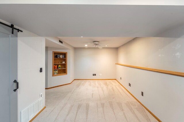 1013 10th Ave NW, Altoona, IA 50009 - basement featuring carpet floors, baseboards, a barn door, ceiling fan, and recessed lighting