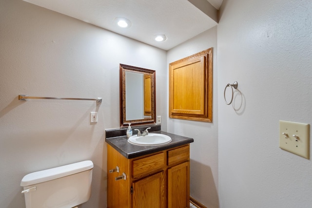 bathroom featuring toilet and vanity