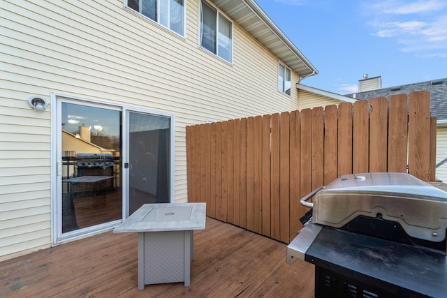 wooden deck with fence and grilling area