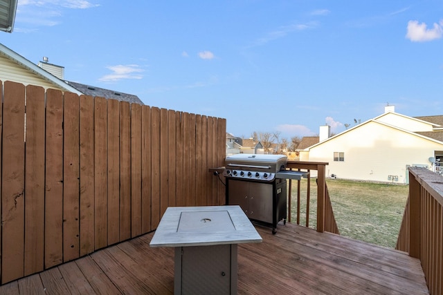 deck with grilling area and a yard