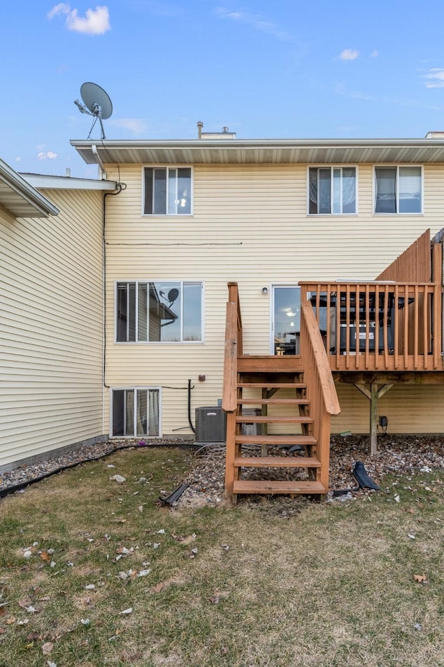 rear view of house with stairway, cooling unit, a yard, and a wooden deck