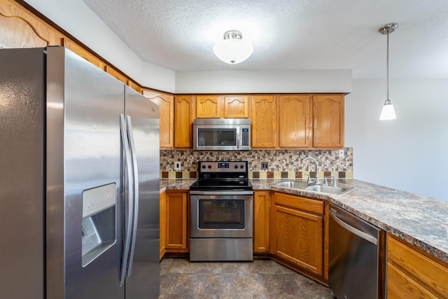 1013 10th Ave NW, Altoona, IA 50009 - kitchen with stainless steel appliances, a sink, brown cabinets, decorative backsplash, and a textured ceiling