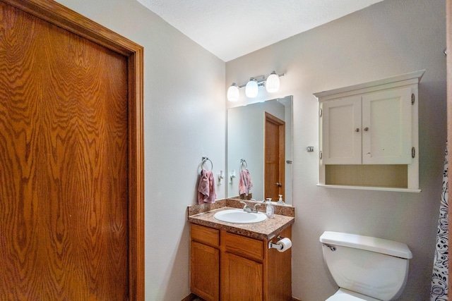 bathroom featuring toilet and vanity