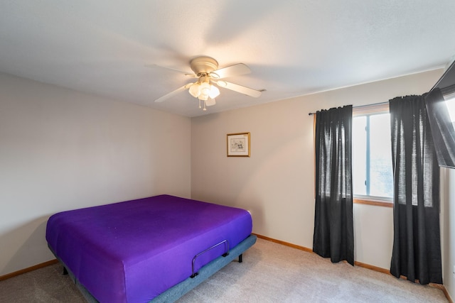 bedroom with ceiling fan, baseboards, and carpet