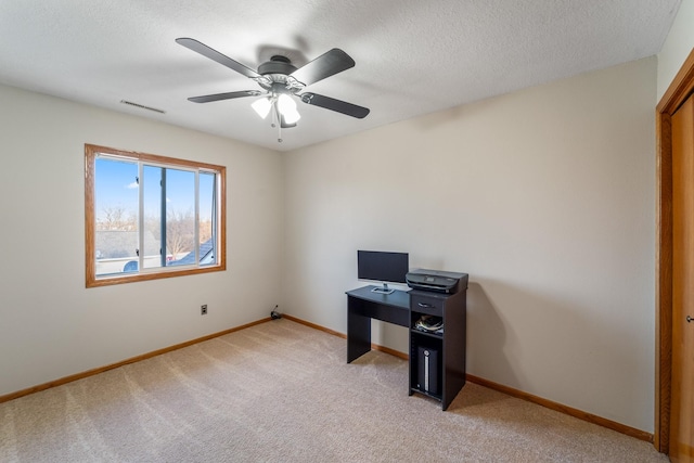 home office featuring light carpet, visible vents, ceiling fan, and baseboards