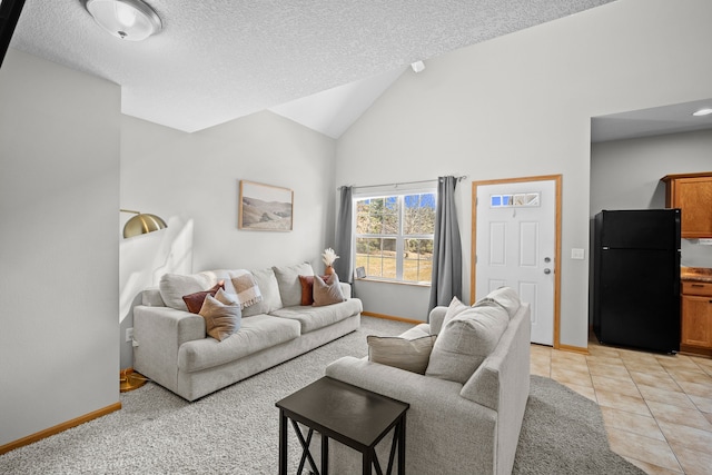 living room featuring light tile patterned flooring, a textured ceiling, baseboards, and vaulted ceiling