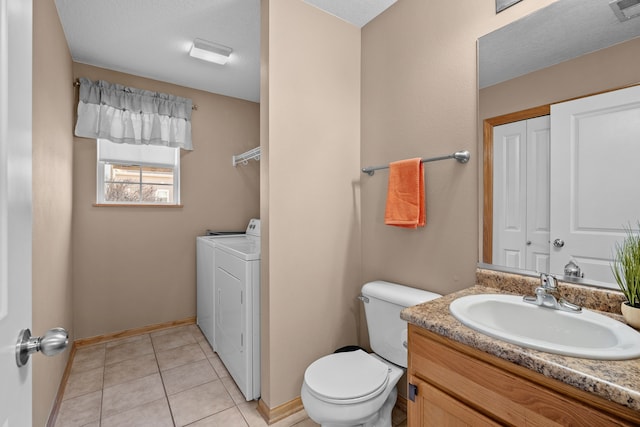 bathroom with tile patterned floors, toilet, a closet, vanity, and separate washer and dryer