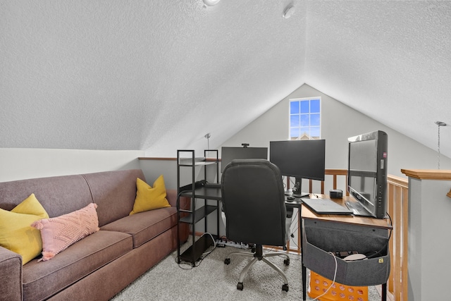 carpeted home office featuring lofted ceiling and a textured ceiling