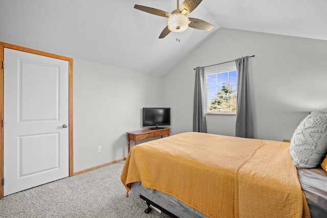 bedroom featuring baseboards, ceiling fan, carpet flooring, and vaulted ceiling