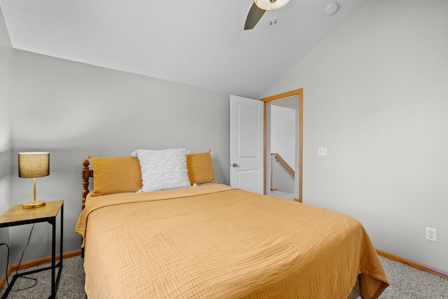 carpeted bedroom with baseboards, ceiling fan, and vaulted ceiling