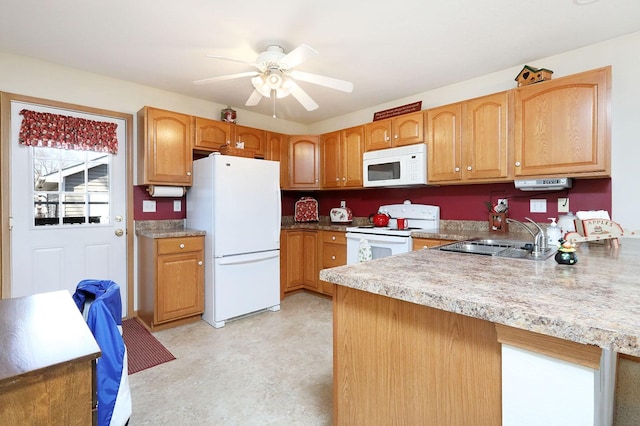 kitchen with white appliances, a ceiling fan, a peninsula, a sink, and light countertops