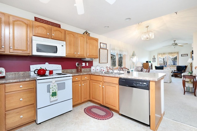 kitchen with lofted ceiling, ceiling fan with notable chandelier, a peninsula, white appliances, and a sink