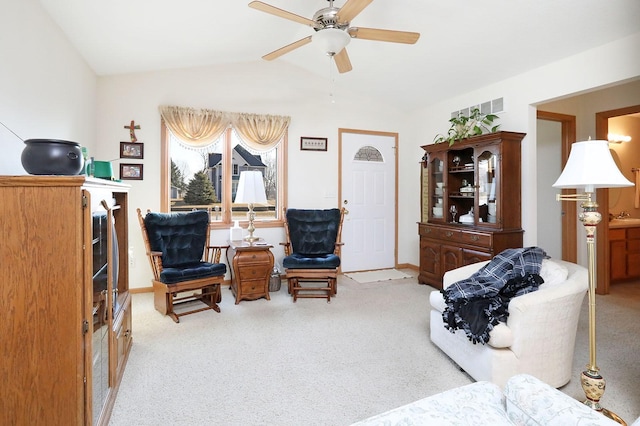 sitting room with carpet, ceiling fan, and vaulted ceiling