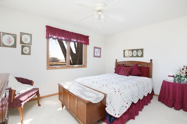 bedroom with light carpet, ceiling fan, and baseboards