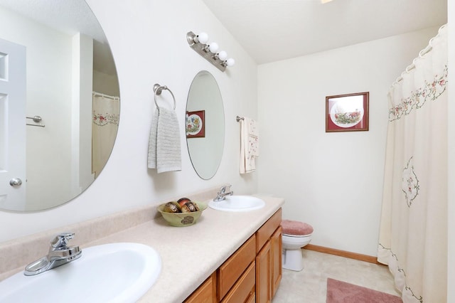 full bathroom featuring a sink, baseboards, toilet, and double vanity