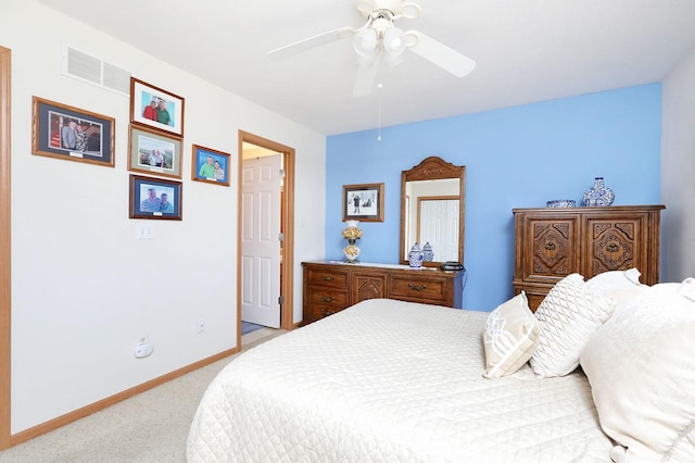 bedroom with visible vents, baseboards, light colored carpet, and a ceiling fan