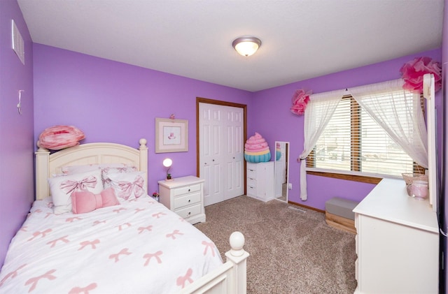 bedroom with a closet, baseboards, carpet, and visible vents