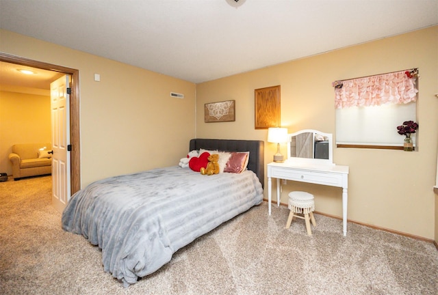 carpeted bedroom with visible vents and baseboards