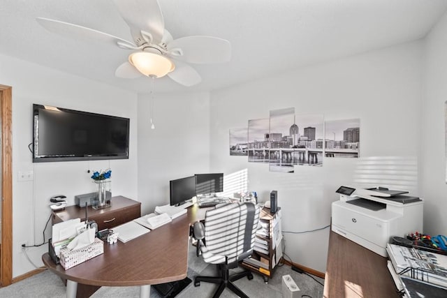 home office featuring baseboards, a ceiling fan, and carpet flooring